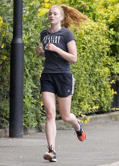 Sophie Turner in shorts jogging in London