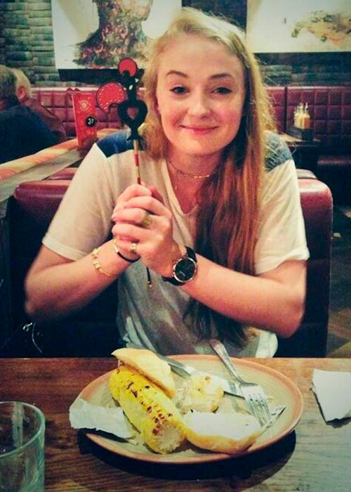 Sophie Turner posing before eating corn