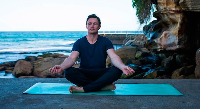 James Duigan doing yoga seaside