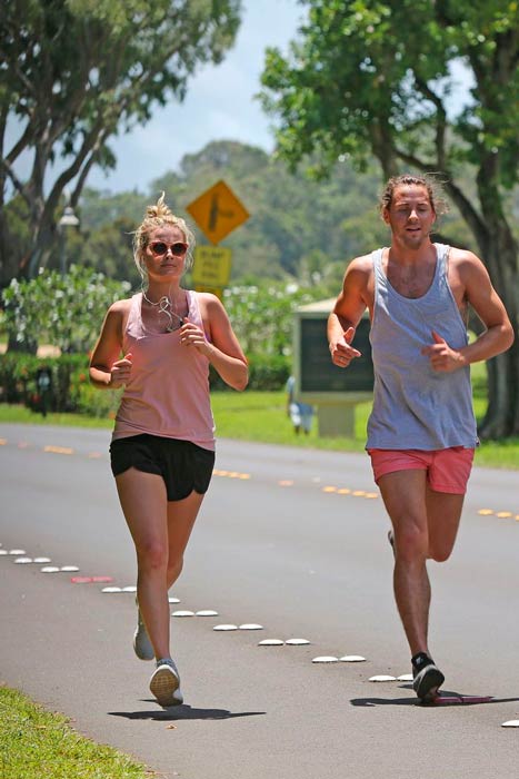 Margot Robbie running outdoors with her partner