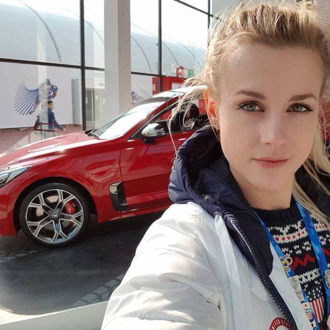 Madison Hubbell in a selfie with a red car on Valentine's Day 2018