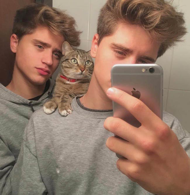 The Martinez twins Emilio and Ivan Right with their cat Lukas Martinez in March 2017