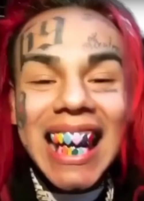 6ix9ine showing his teeth while speaking about his past in 2018