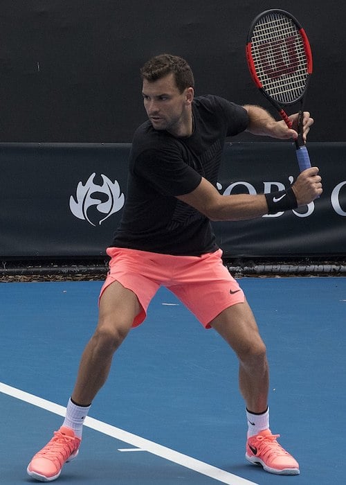 Grigor Dimitrov playing the shot in a tennis match held in 2018