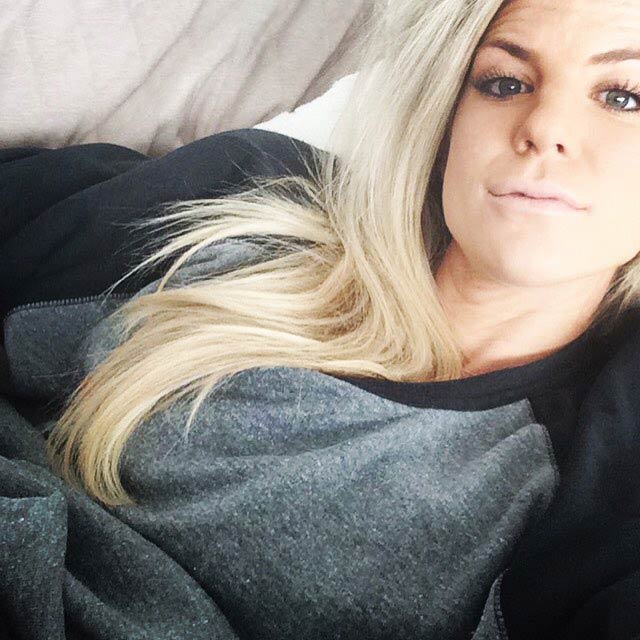 Julie Ertz sitting on a lovesac couch in a selfie in 2015