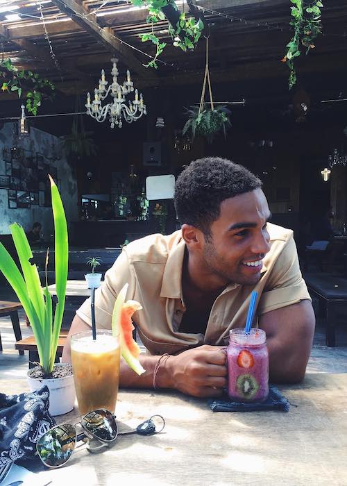 Lucien Laviscount having a smoothie at Strawberry Fields in Bali, Indonesia in 2016