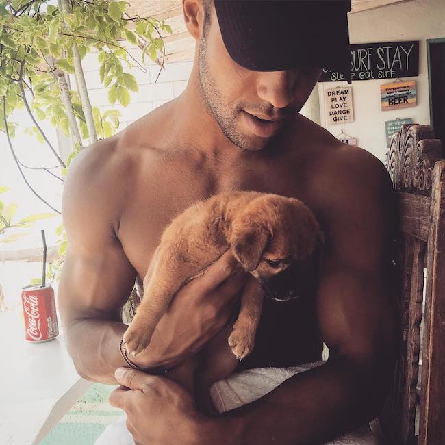 Lucien Laviscount with a pup in 2016
