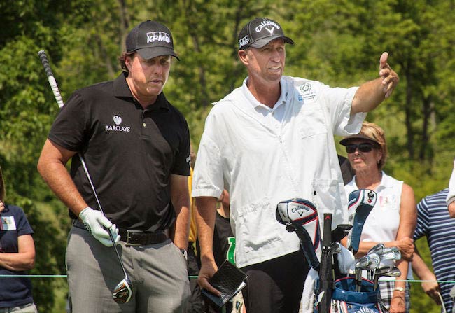 Phil Mickelson talking to his caddy Jim Bones' MacKay at Muirfield Village Golf Club in 2014