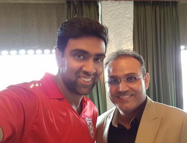 Ravichandran Ashwin with Virender Sehwag in March 2018 after jersey launch of IPL team KXIP