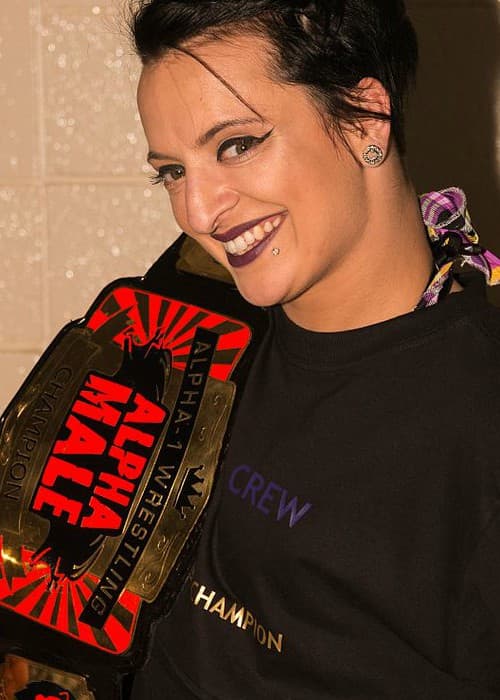 Ruby Riott posing with Alpha Male championship belt in July 2016