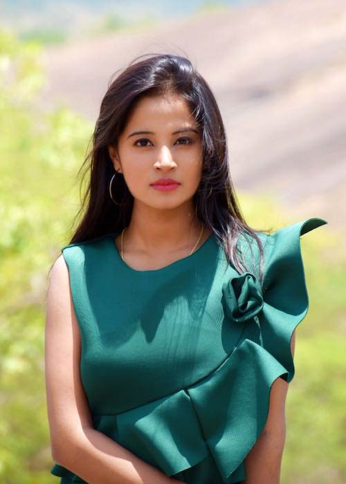 Anusha Rai in green dress during a photoshoot in 2017