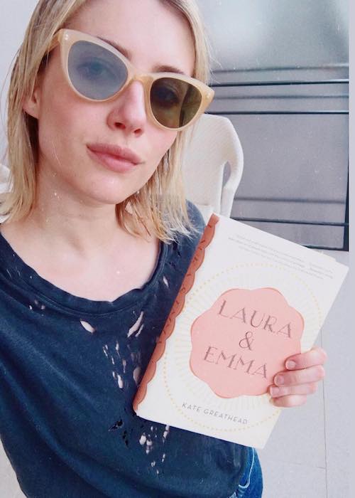 Emma Roberts holding the book Laura and Emma by Kate Greathead in April 2018