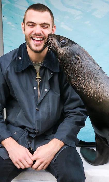 Alex Roe enjoying his time with a seal in July 2017