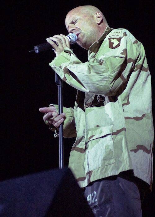 Bruce Willis performing with his band members of the Accelerators for 101st Airborne Division soldiers in Iraq in September 2003