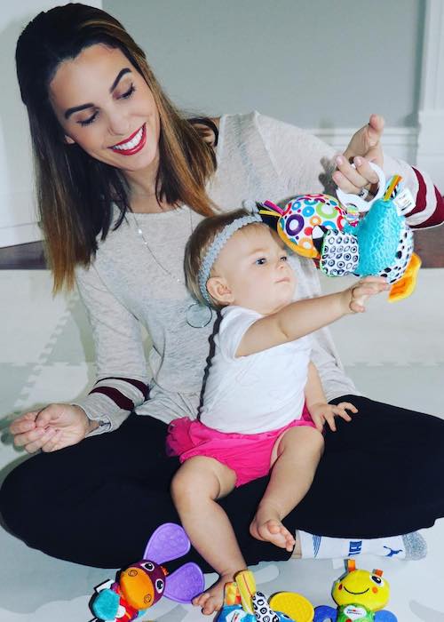 Christy Carlson Romano's daughter Isabella playing with toys in October 2017