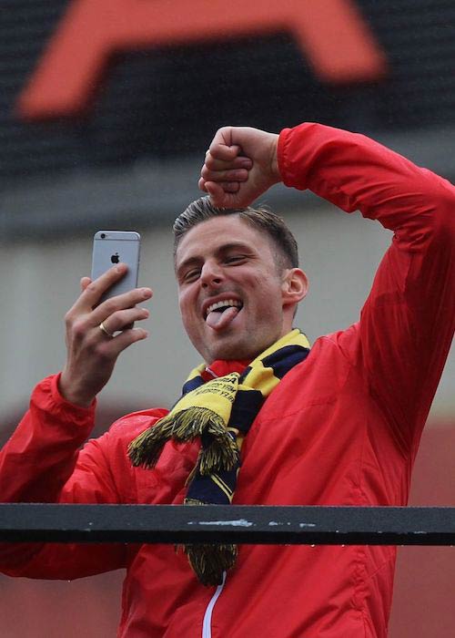 Olivier Giroud celebrating during the Arsenal FA Cup Parade in 2015