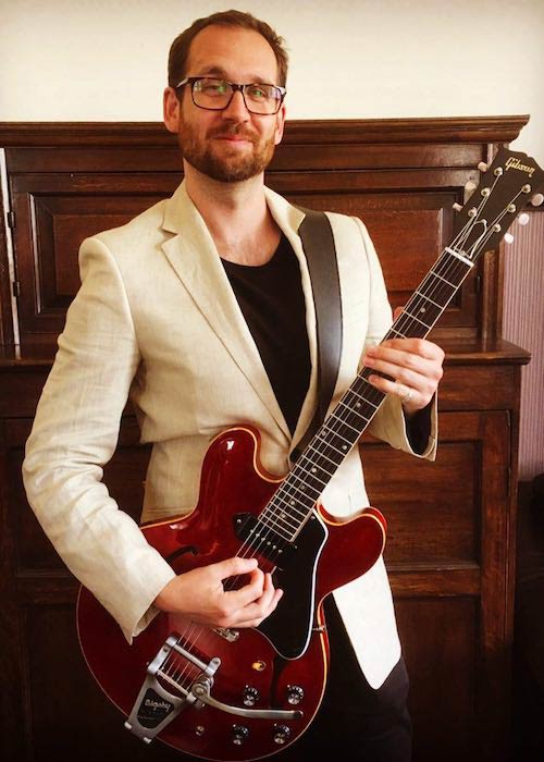 Will Farquarson wearing linen jacket and playing Gibson 330 guitar in May 2017