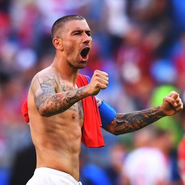 Aleksandar Kolarov cheering while showing his lean physique in 2018