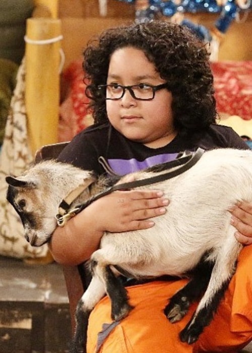 Nathan Arenas with Gilbert-the goat in a still from the show Bunk'd