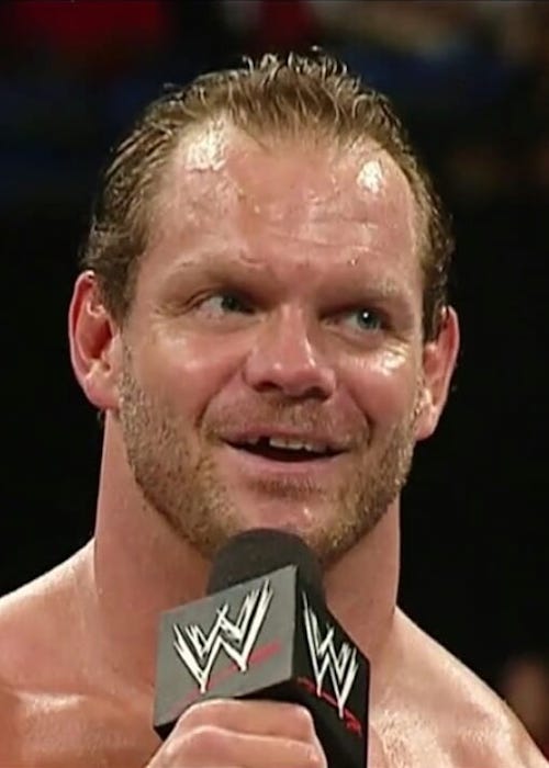 Chris Benoit while talking with fans inside the ring