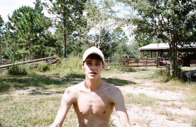 Israel Broussard shirtless during an outdoor selfie in October 2016