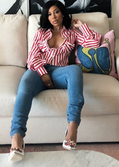 K. Michelle while posing on the couch in July 2018