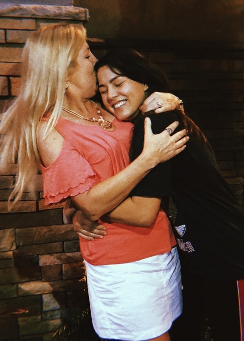 Megan Batoon embracing her mother in a tight hug in May 2018