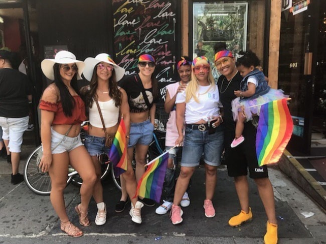 Sijara Eubanks (Corner Right) holding her baby while celebrating the NYC Pride March with her friends in May 2018