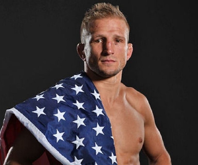 TJ Dillashaw posing with the American flag