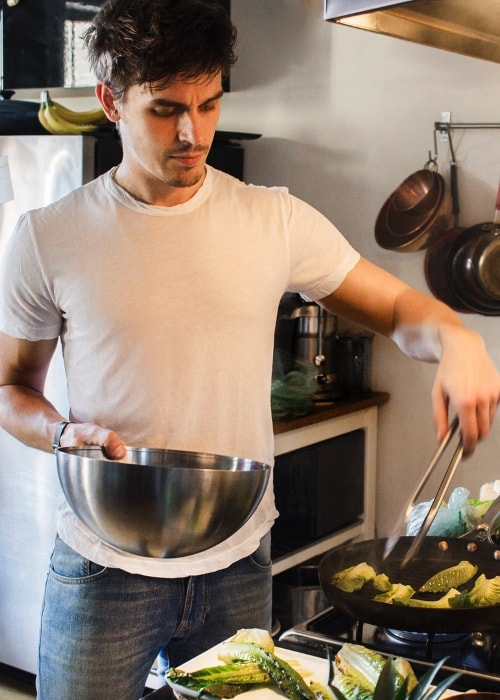 Antoni Porowski while preparing a meal in July 2018