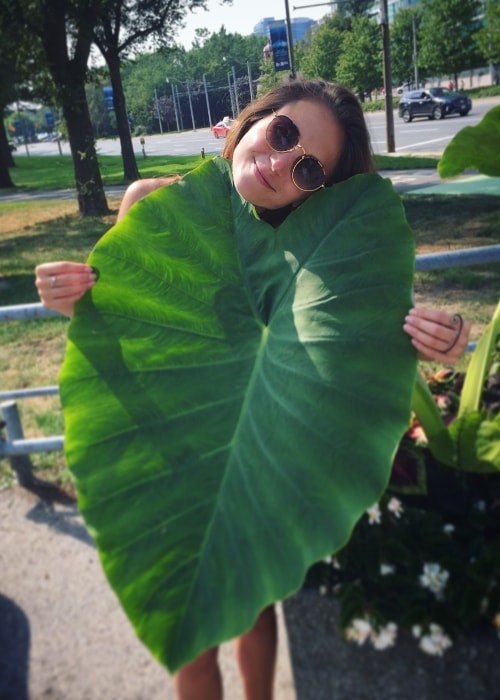 Dominique Provost-Chalkley posing with a giant leaf in February 2018