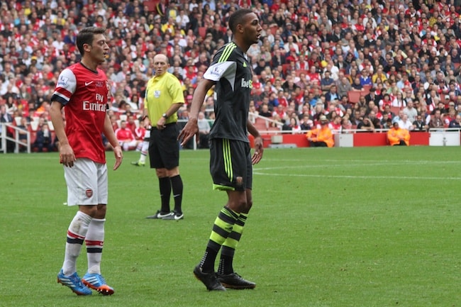 Mesut Özil and Steven N'Zonzi while standing on the football ground during AFC vs Stoke match in September 2013