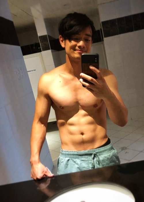 Osric Chau showing his toned physique in a shirtless mirror selfie in August 2018