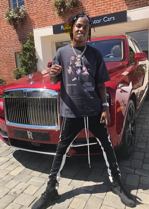 Rich the Kid posing with his new Rolls Royce truck in August 2018