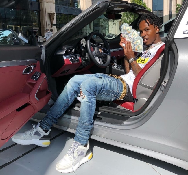 Rich the Kid showing off his riches with his Porsche and cash in August 2018
