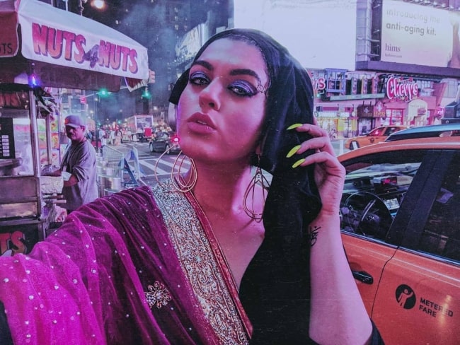 Amani Al-Khatahtbeh taking a selfie at Times Square, New York City in September 2018