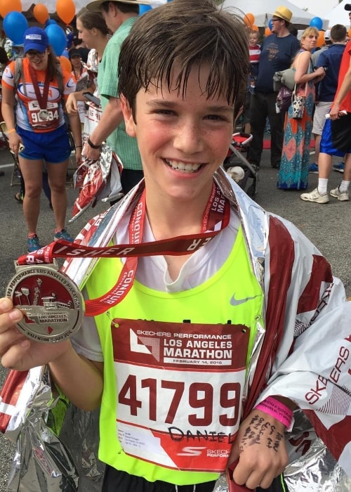 Daniel DiMaggio posing with his medal after running 26.2 miles in the Los Angeles Marathon in February 2016