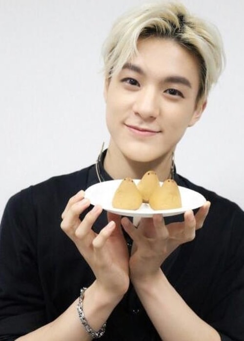 Jeno with a plate of cakes in October 2017