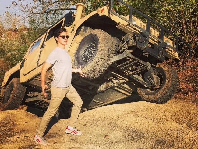 Joey Bragg posing while fake-lifting a truck in October 2017