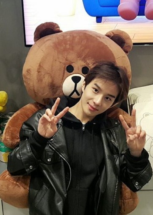 Jungwoo posing with a stuffed bear in May 2017