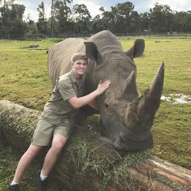 Robert Irwin with a rhinoceros at Australia Zoo in September 2018
