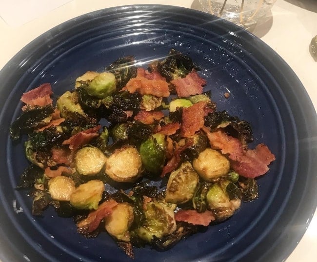 A meal prepared with ingredients like brussels sprouts and bacon