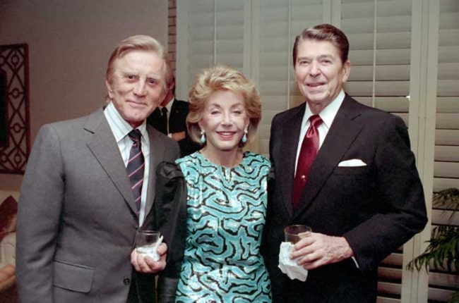 Kirk Douglas with wife Anne Buydens and former U.S. President Ronald Reagan (Right) at a private dinner at the Eldorado Country Club, California in December 1987