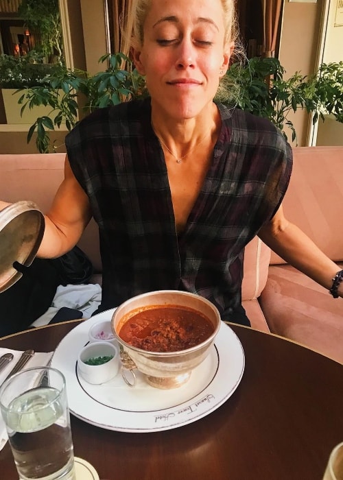 Lacey Stone posing happily with her delicious meal in October 2018