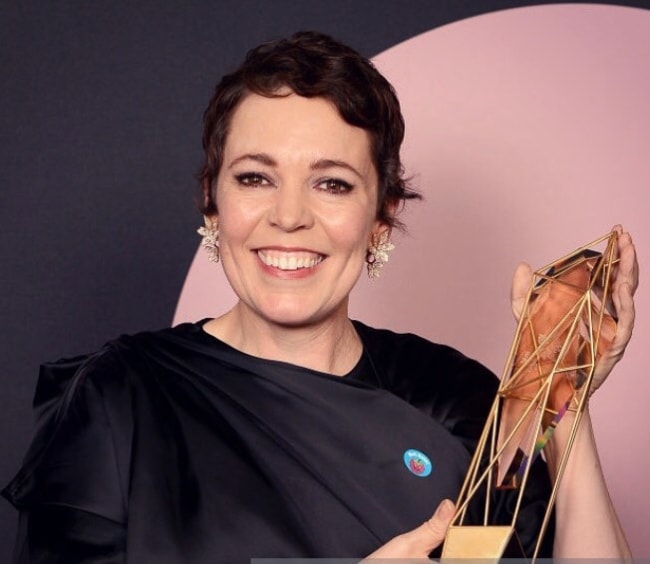 Olivia Colman posing with a trophy