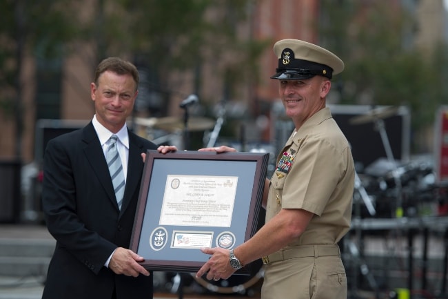 Gary Sinise being honored as an honorary chief petty officer by Fleet Master Chief Michael Stevens during a ceremony at the Navy Memorial and Naval Heritage Center in August 2012