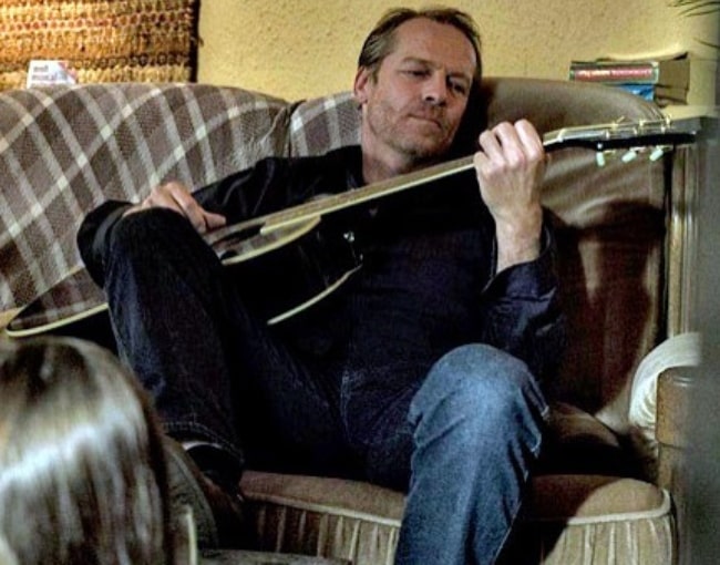 Iain Glen as seen with his guitar