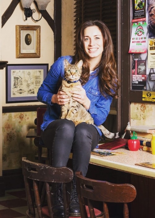 Julia Goulding posing with her cat