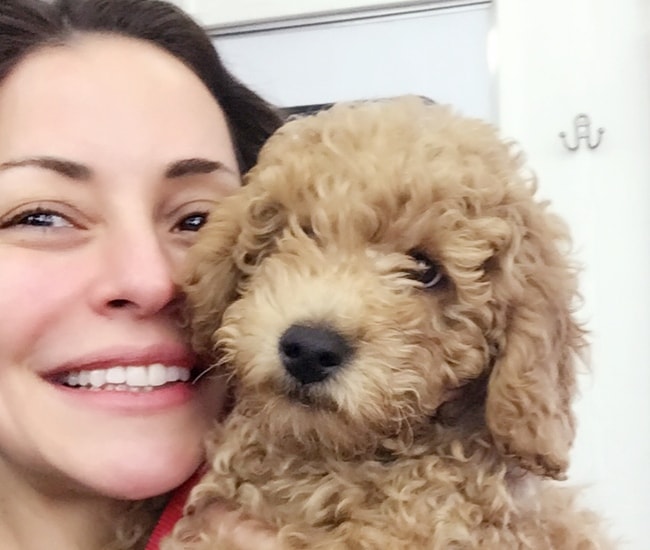 Emmanuelle Vaugier in a selfie with Charlie, a golden doodle, in December 2017