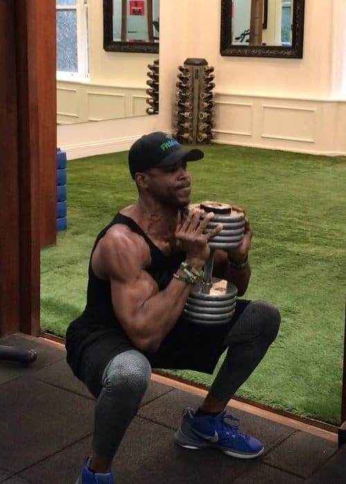 Ngo Okafor doing Dumbbell Squats in December 2018